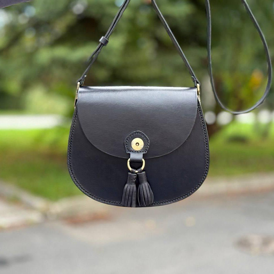 Black leather satchel with saddle stitching close‑up  
