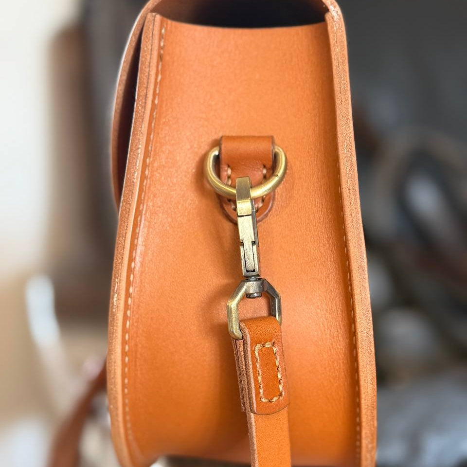  Adjustable tan leather strap with brass buckle  
