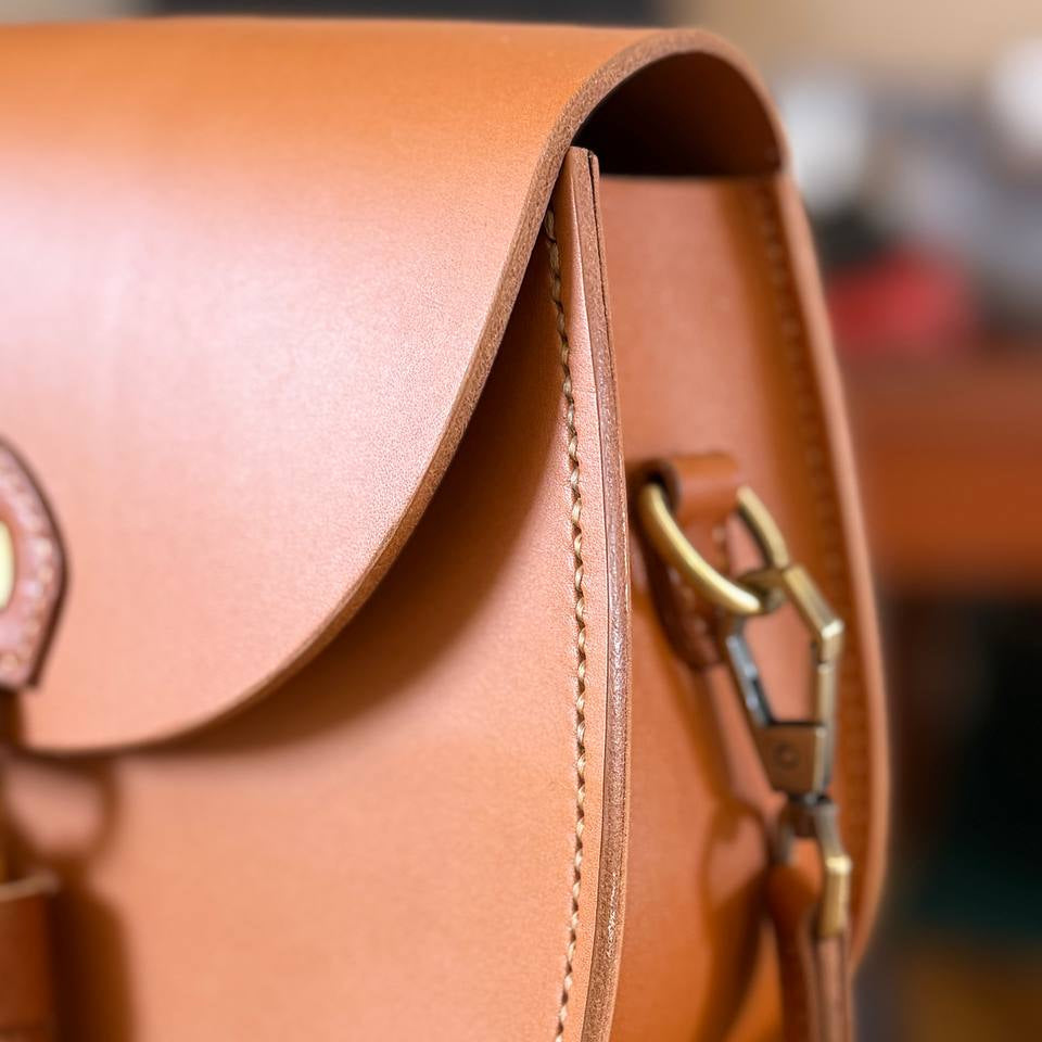 Handmade tan leather crossbody bag with brass hardware  