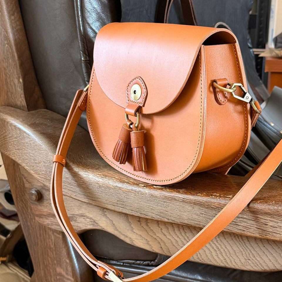  Tan vegetable‑tanned leather satchel on chair  