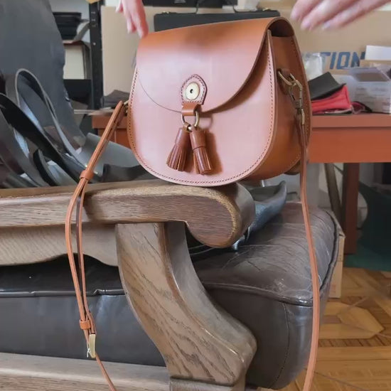 Magnetic clasp on tan leather satchel  