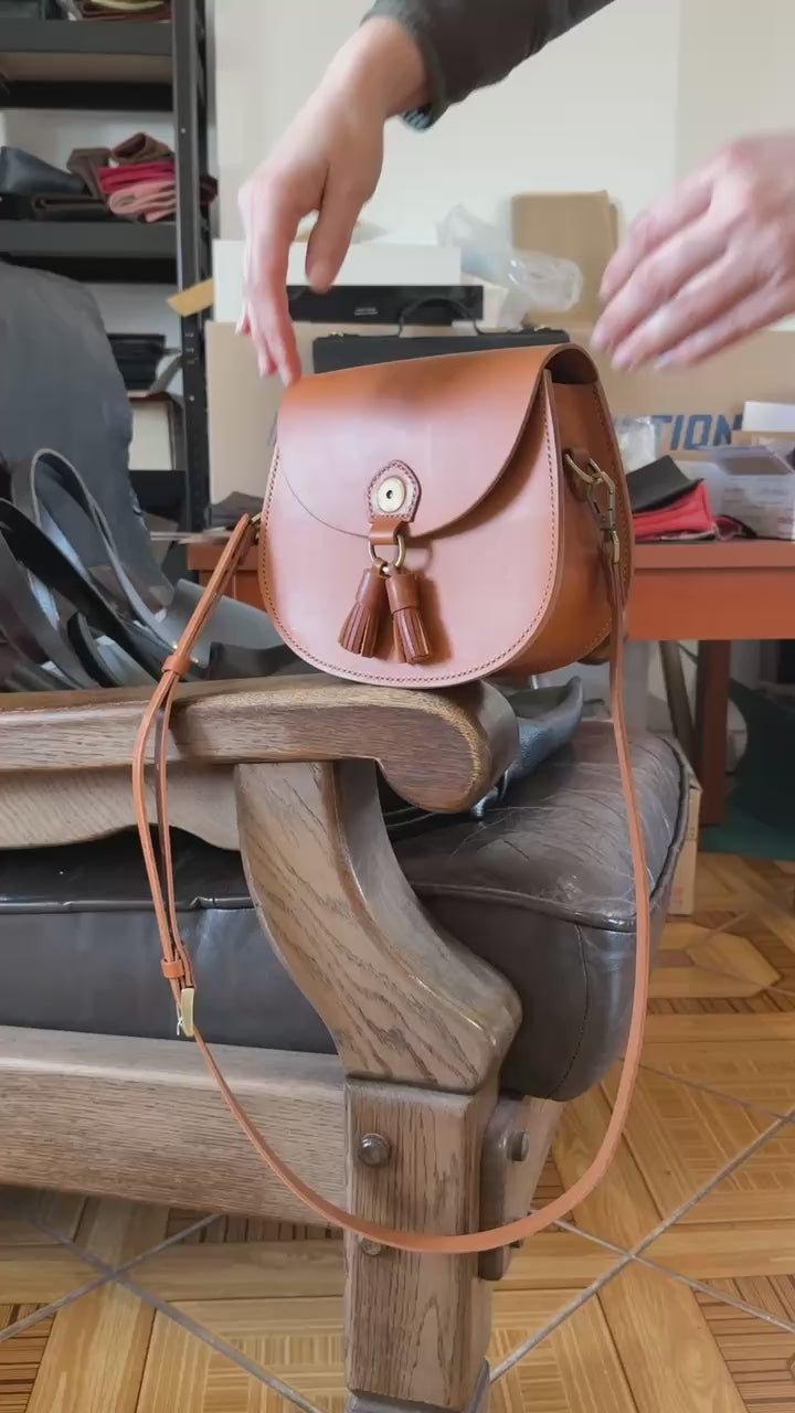 Magnetic clasp on tan leather satchel  
